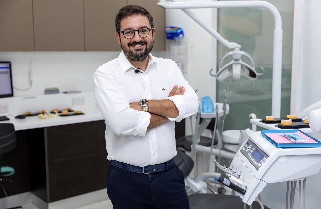 Dr Serhan Okutan standing in a dental surgery